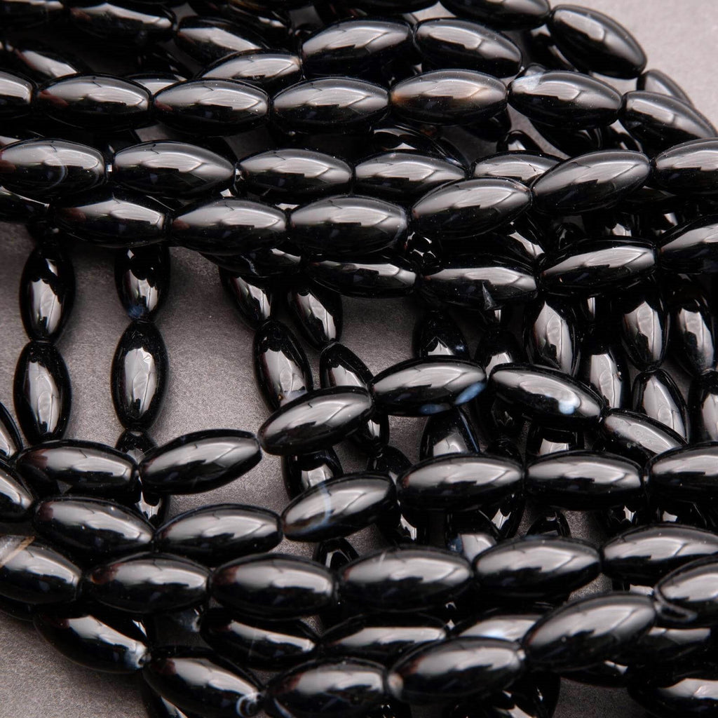Close-up of black oval beads on a light gray background