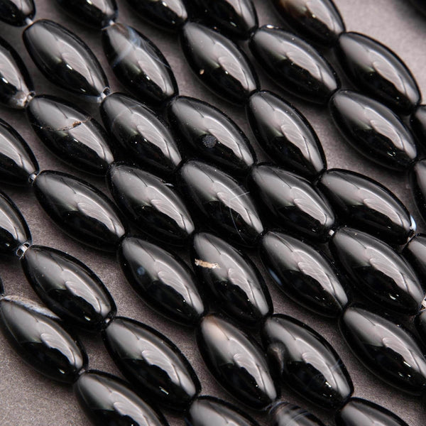 Close-up of black oval beads on a dark surface