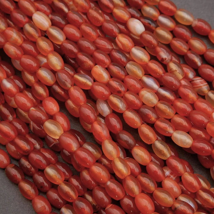 Close-up of red and orange beads on a gray background