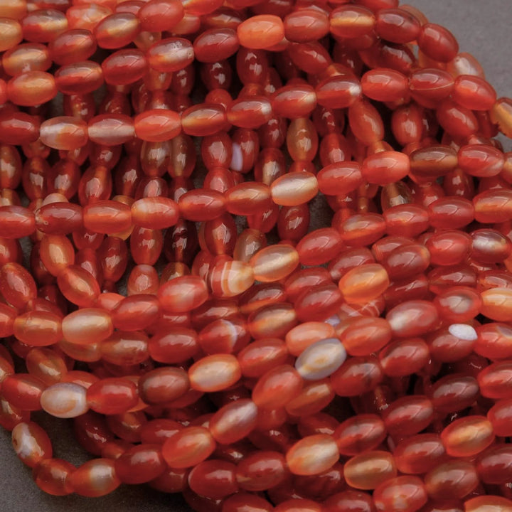 Close-up of a string of red and orange beads.