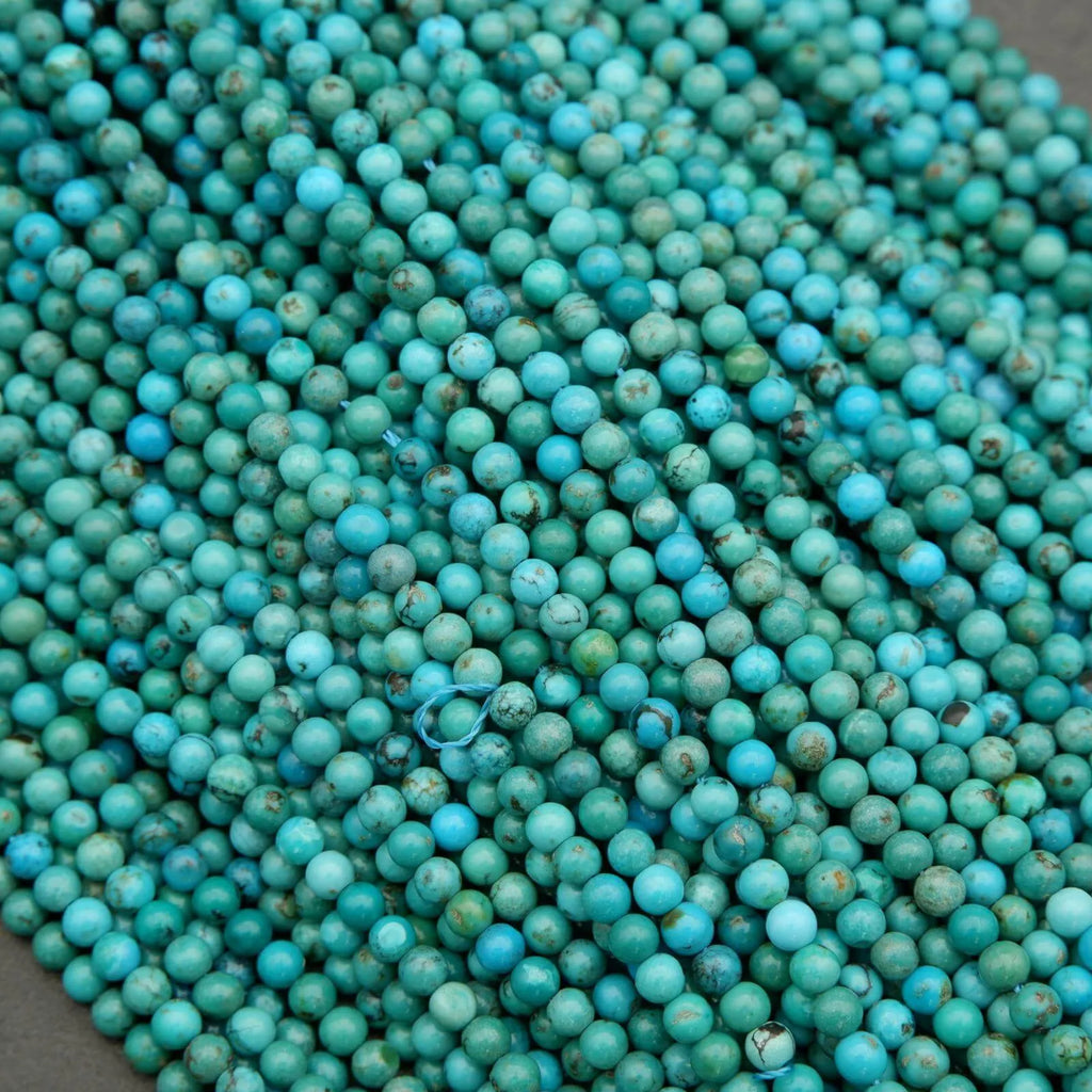 Close-up of turquoise beads on a dark background