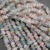 Close-up of multicolored stone beads on a gray background