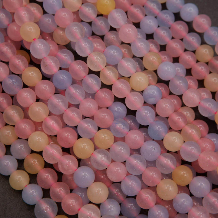 Close-up of dyed jade beads with pink, lavender, peach, and blue colors