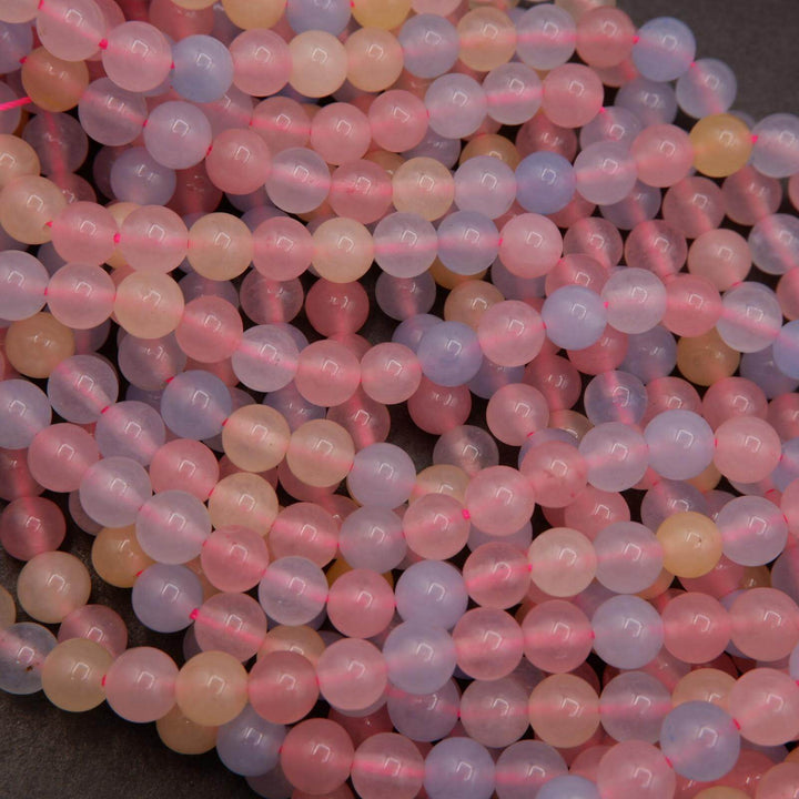 Polished dyed jade round beads designed to mimic beryl appearance