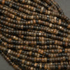 Assorted biotite heishi bead strands arranged in a bundle with natural earth-tone coloration.