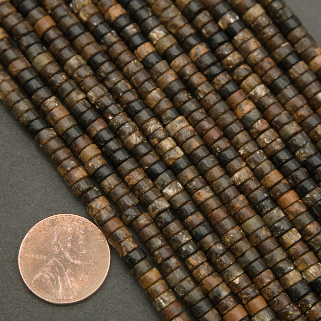 Macro image of biotite heishi beads highlighting mineral texture and subtle metallic flecks.