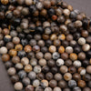 Close-up of multicolored round beads on a gray surface