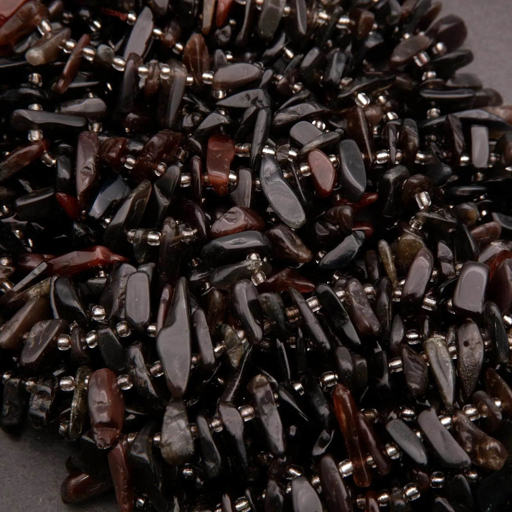 Close-up of dark brown and black beads on a gray background