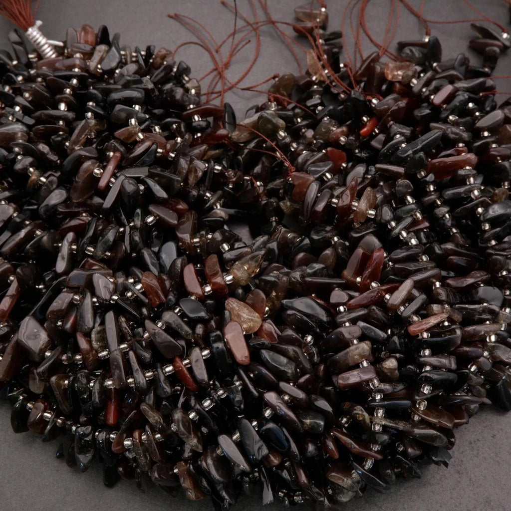 Close-up of dark brown beaded strands on a gray background