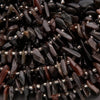 Close-up of dark brown beads with silver accents