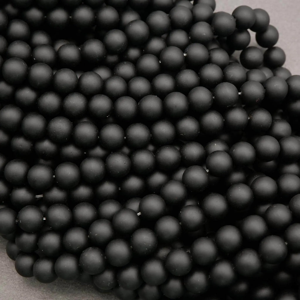 Close-up of black beads on a beige background