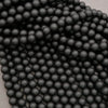 Close-up of black beads on a gray background