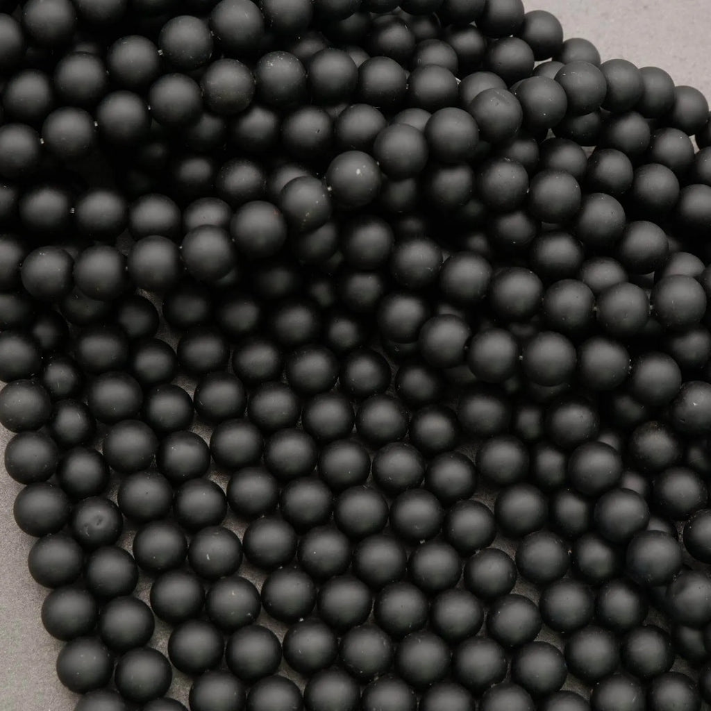 Close-up of black beads on a gray background
