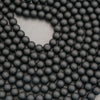 Close-up of black beads arranged in a circular pattern