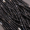 Close-up of black beads on a dark background