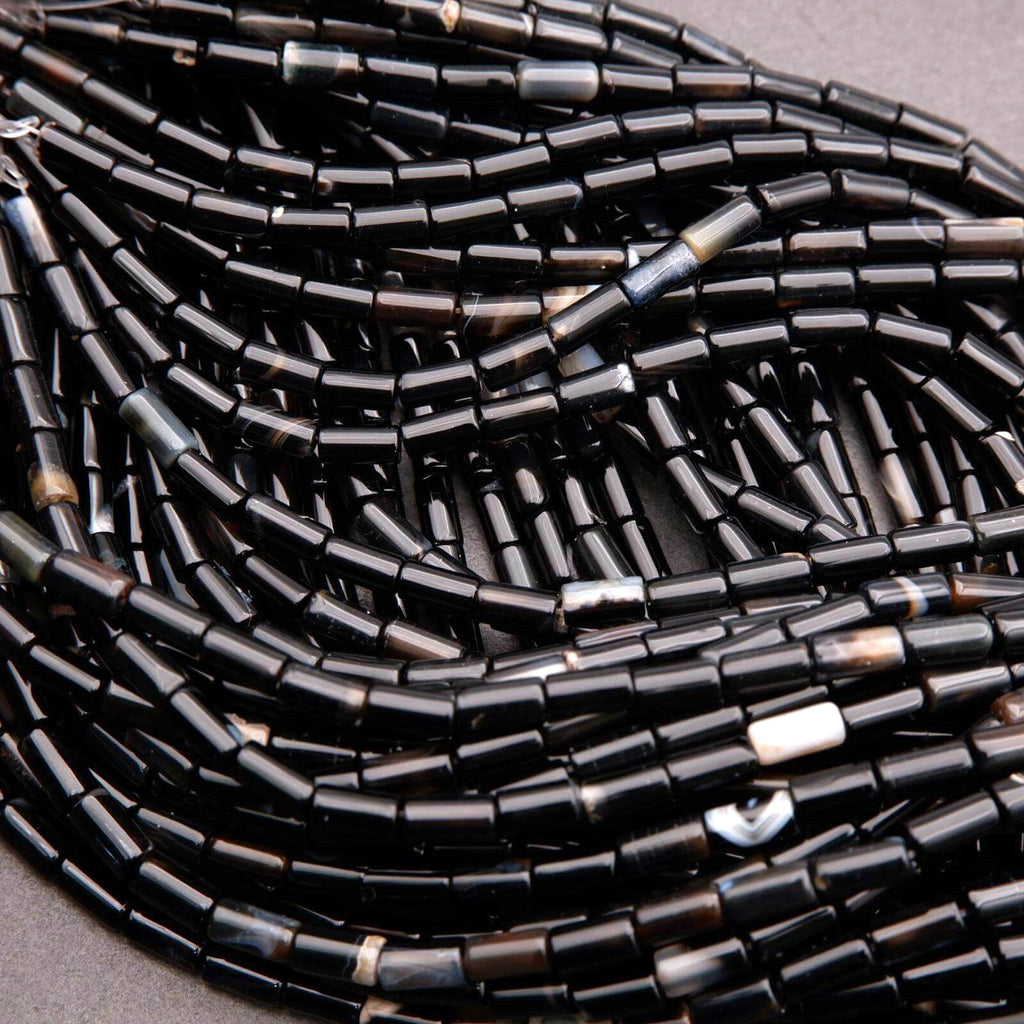Close-up of black beaded strands on a gray background
