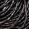 Close-up of black cylindrical beads.
