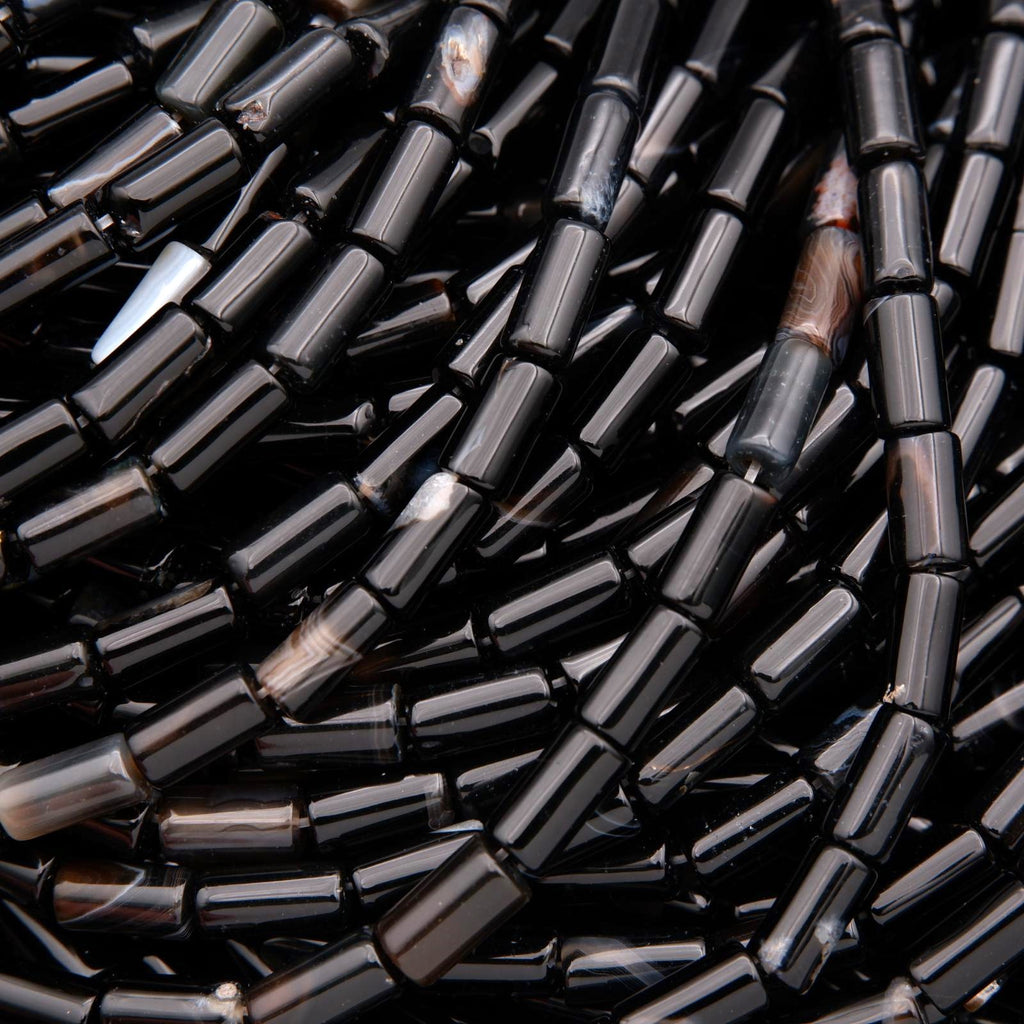Close-up of black cylindrical beads.