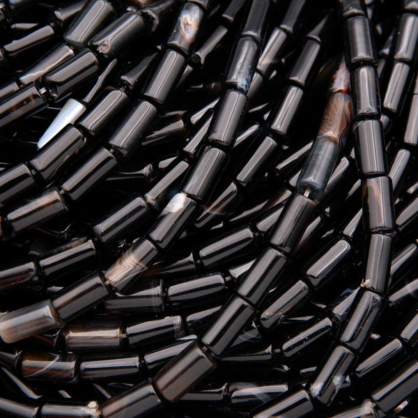 Close-up of black cylindrical beads.