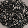 Close-up of dark metallic gravel on a light background
