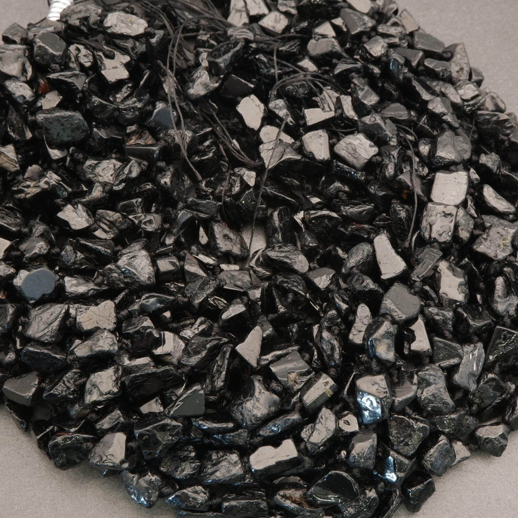 Close-up of dark metallic gravel on a light background