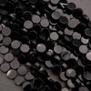Close-up of black rhinestones on a dark background