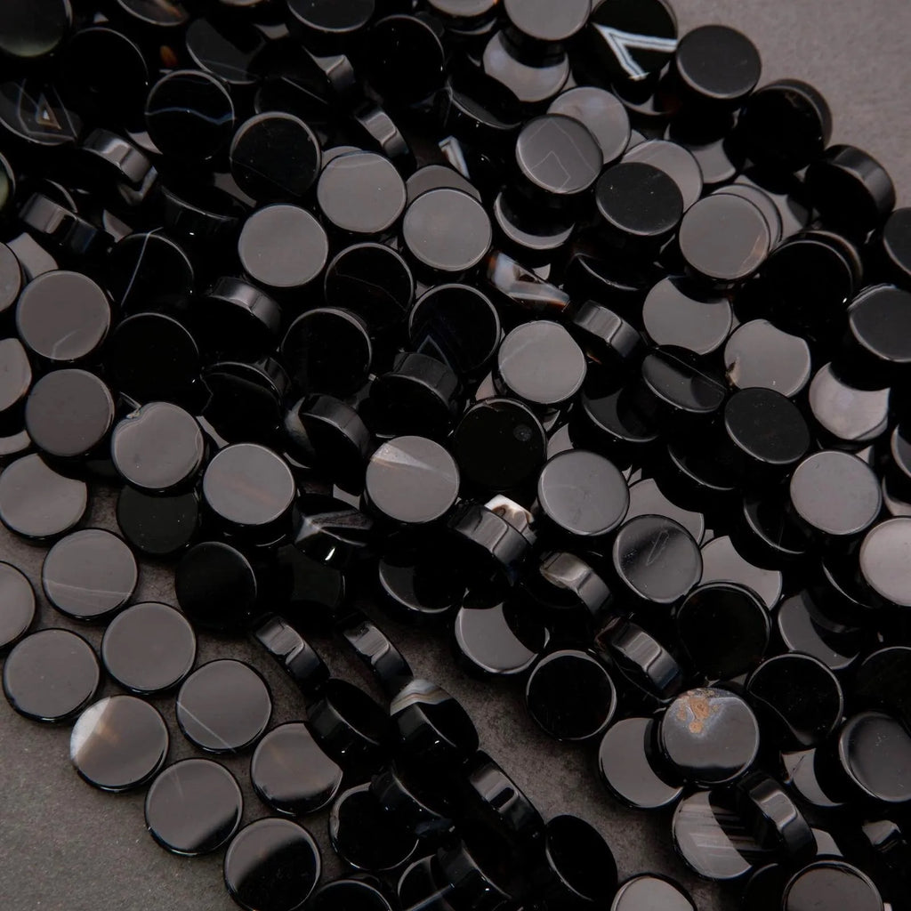 Close-up of black rhinestones on a dark background