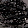 Close-up of a pile of black plastic buttons