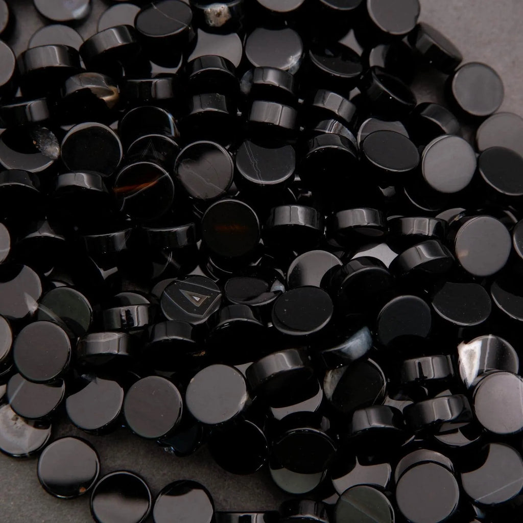 Close-up of a pile of black plastic buttons