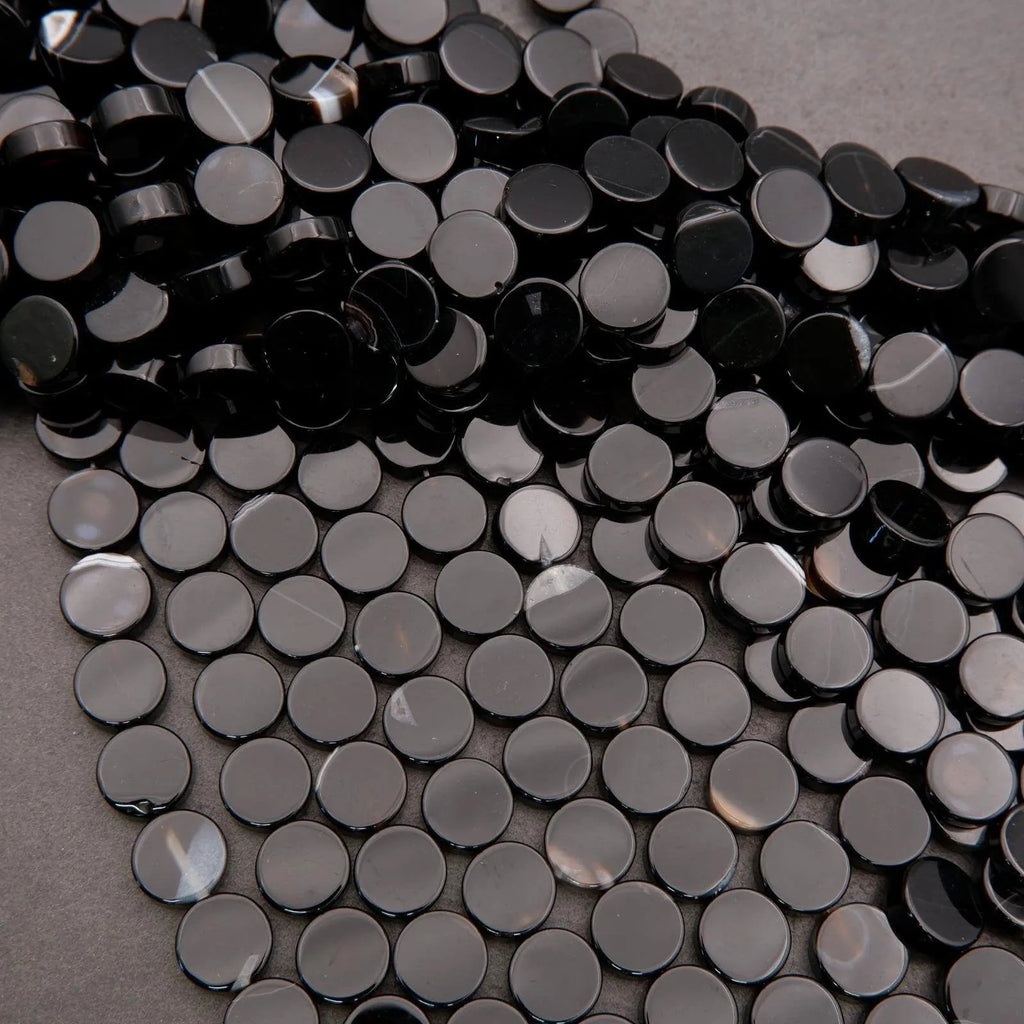 Close-up of black round beads on a gray background