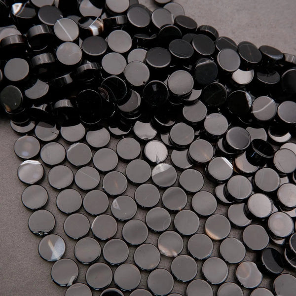 Close-up of black round beads on a gray background