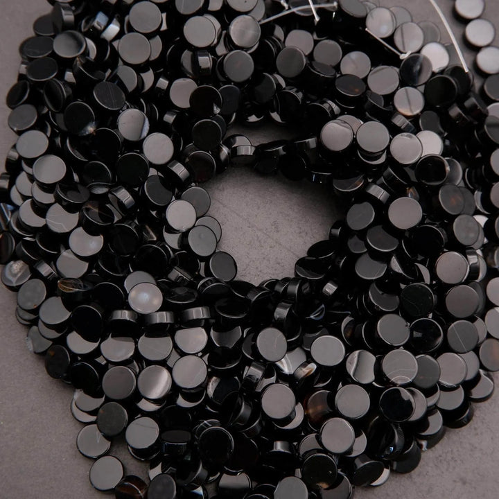 Close-up of black sequins on a gray background