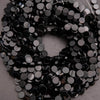 Close-up of black sequins on a gray background