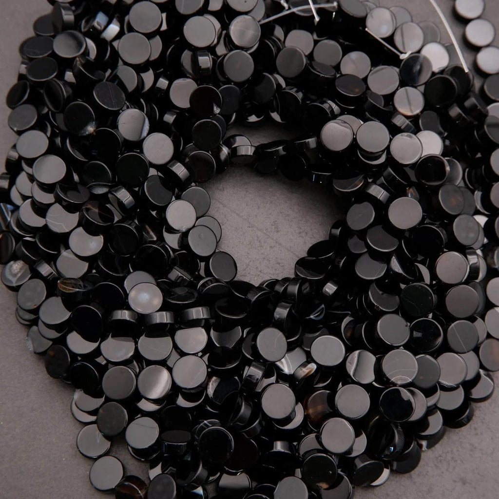 Close-up of black sequins on a gray background