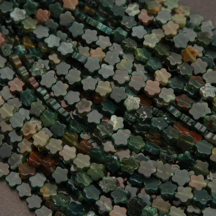 Close-up of a string of multicolored flower-shaped beads.