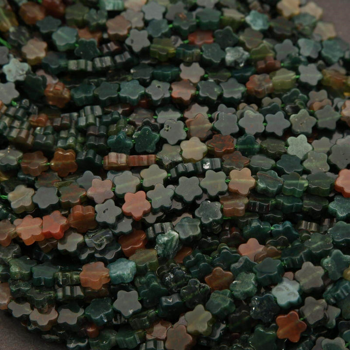 Close-up of a string of multicolored flower-shaped beads.
