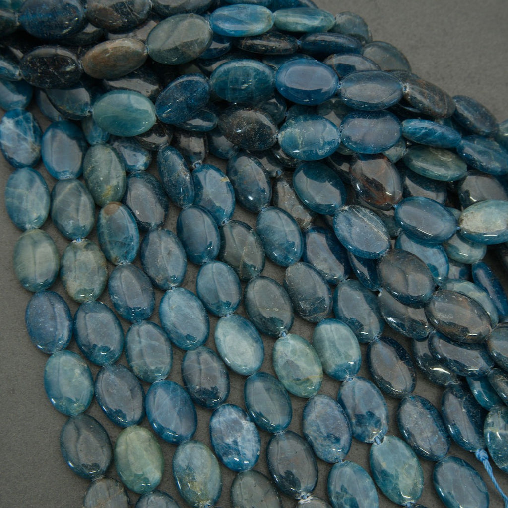 Assorted blue apatite bead strands featuring oval shapes and rich blue hues.