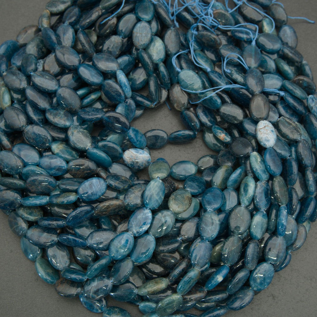 Macro image of blue apatite beads highlighting glossy finish and natural mineral texture.