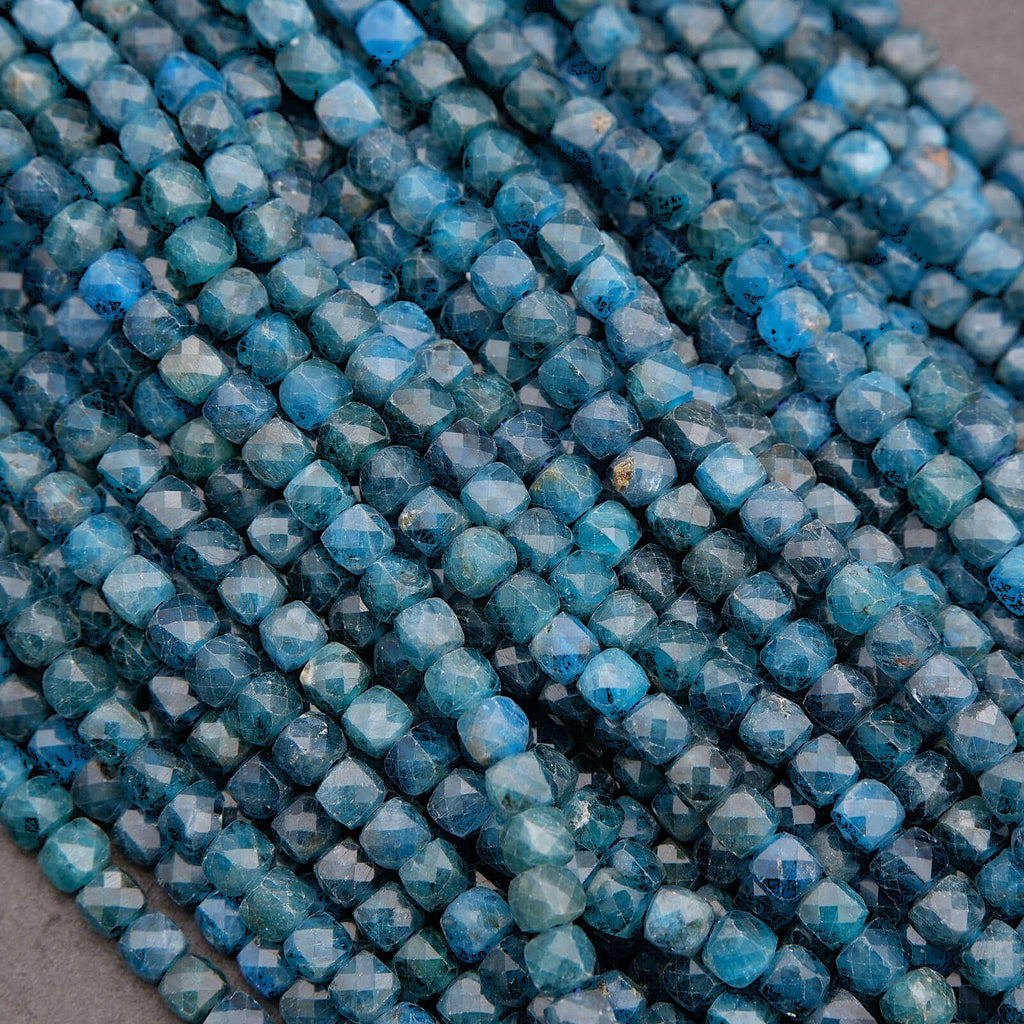 Close-up of blue faceted beads on a gray background