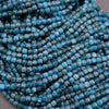 Close-up of blue faceted beads on a gray background