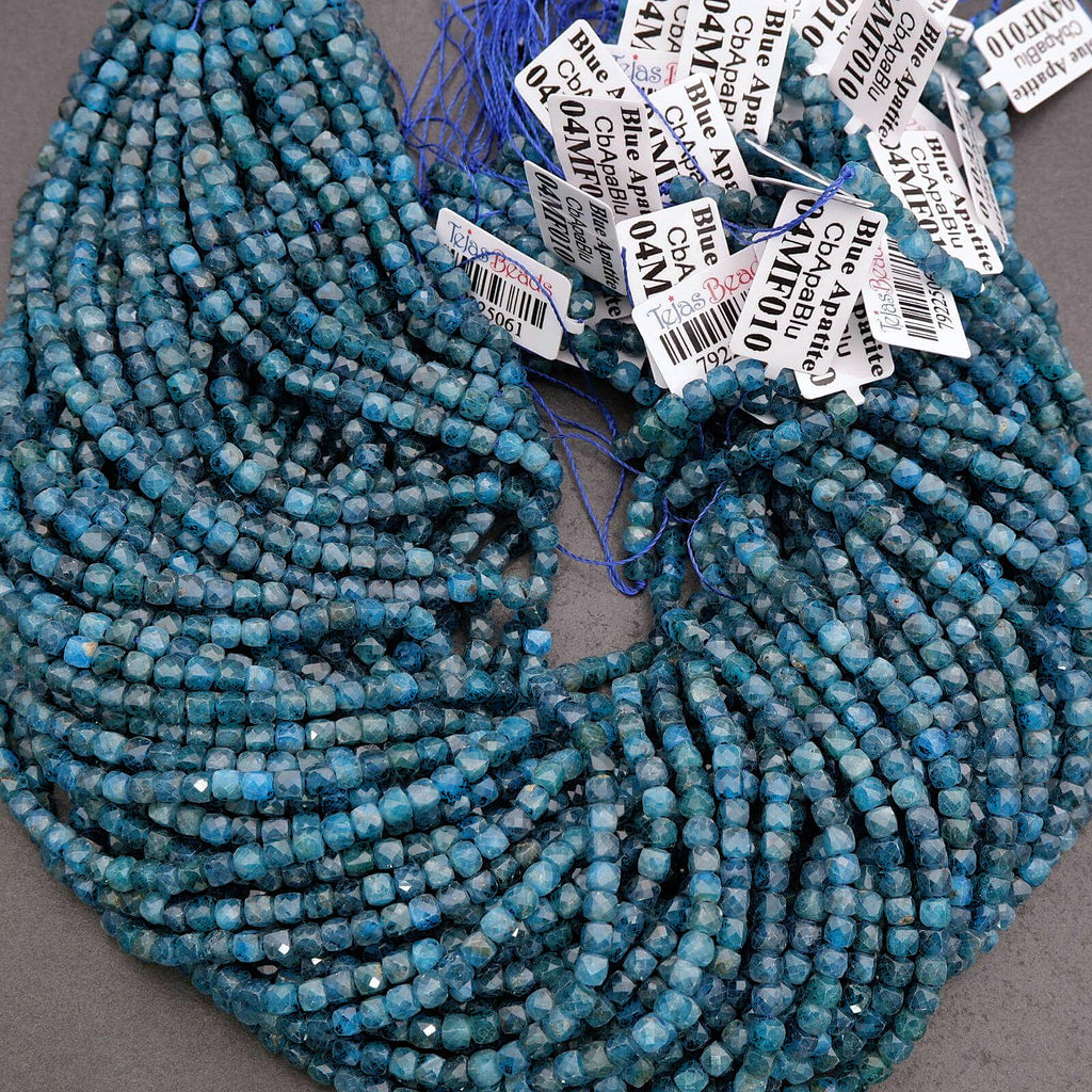Two strands of blue beads with price tags on a gray background