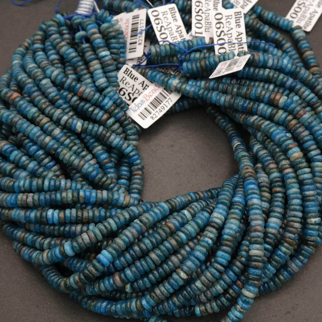 Bunch of blue beads with price tags on a gray surface