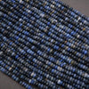Close-up of blue stone beads on a dark background