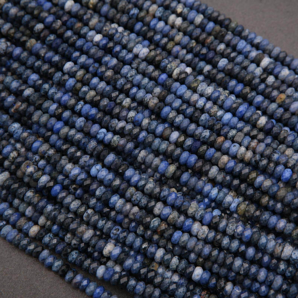 Close-up of blue stone beads on a dark background