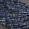 Close-up of a string of blue beads on a dark background
