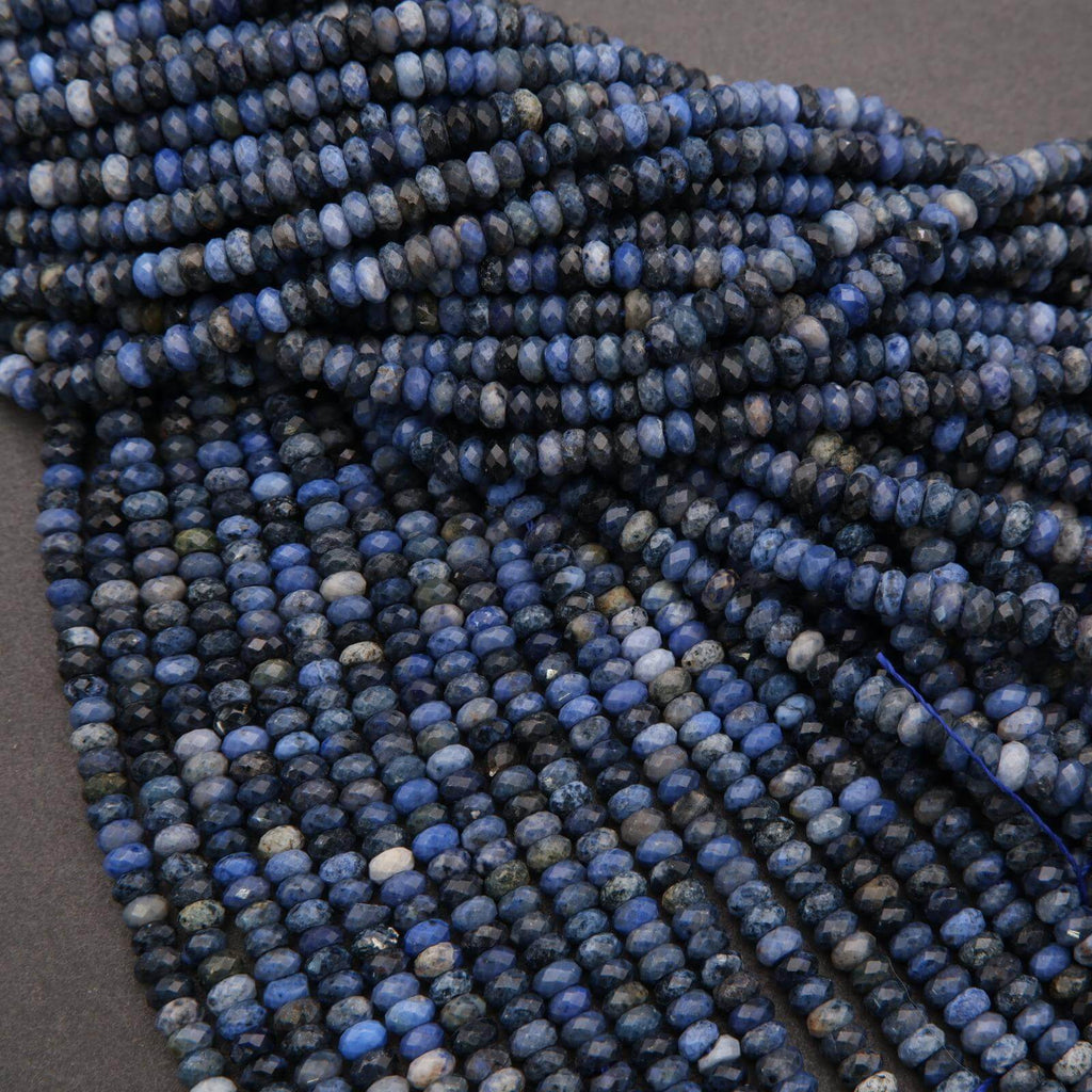 Close-up of a string of blue beads on a gray background