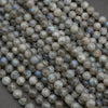 Close-up of round labradorite beads on a dark background