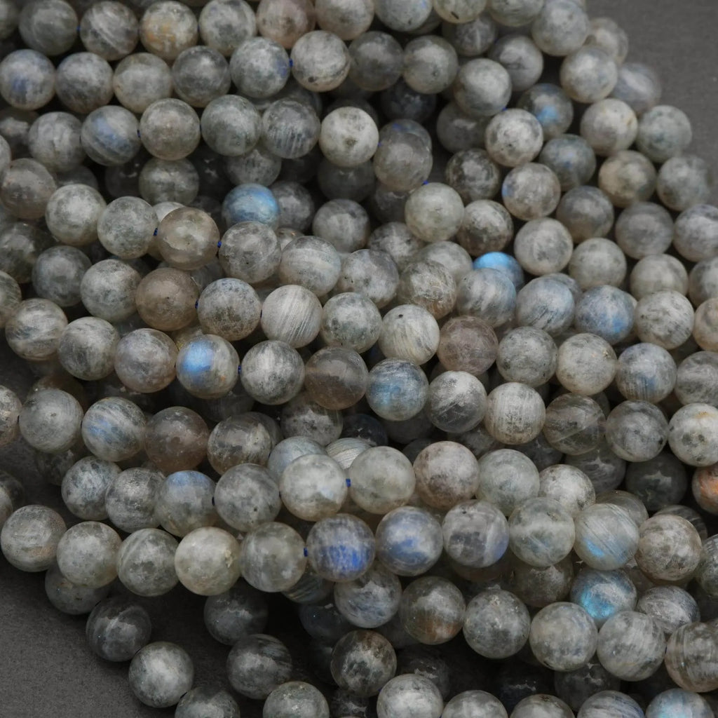 Close-up of round labradorite beads on a dark background