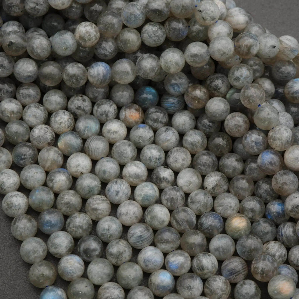 Close-up of grayish-blue beads on a textured surface