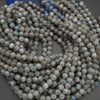 String of round beads on a gray background